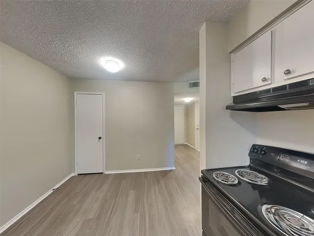 a kitchen with a stove and a microwave
