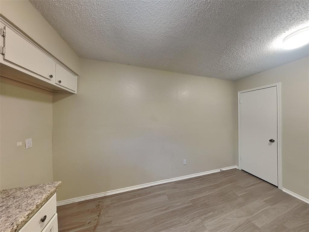 852 Northwest Summercrest Boulevard, Unit B Burleson, TX 76028 - Photo 5 of 13 wooden floor in an empty room