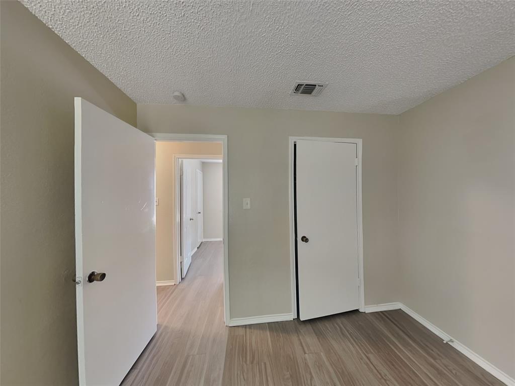 852 Northwest Summercrest Boulevard, Unit B Burleson, TX 76028 - Photo 6 of 13 a view of a hallway with wooden floor