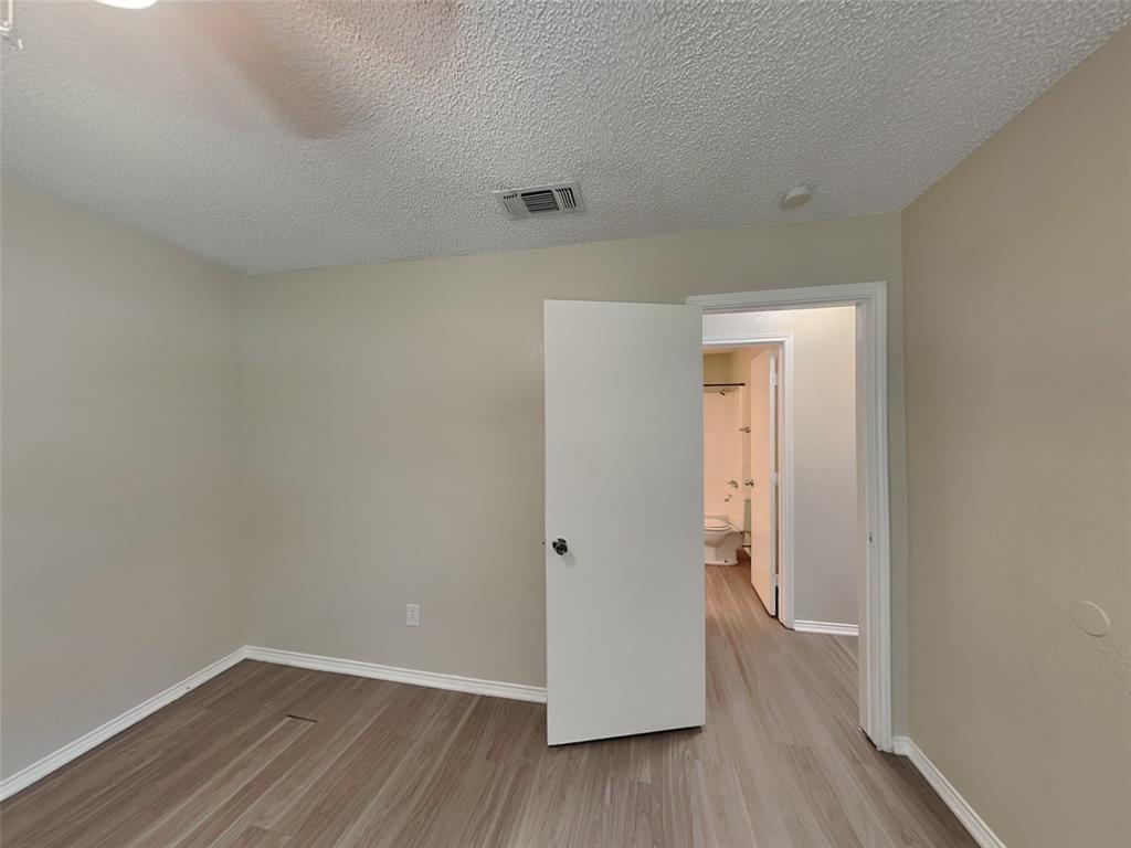 852 Northwest Summercrest Boulevard, Unit B Burleson, TX 76028 - Photo 9 of 13 a view of a room with wooden floor