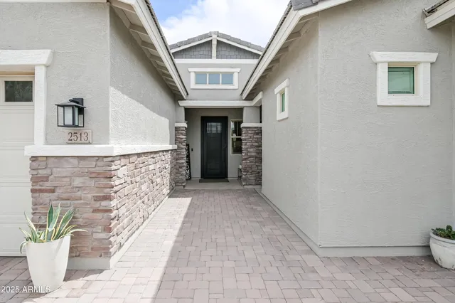 a living room with furniture a flat screen tv and a large window