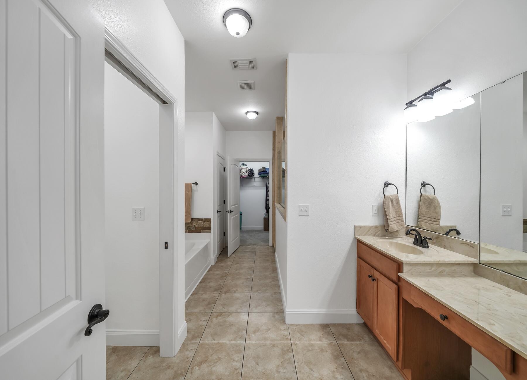 4413 Mirada Way Crestview, FL 32539 - Photo 14 of 30 a bathroom with a sink and a mirror