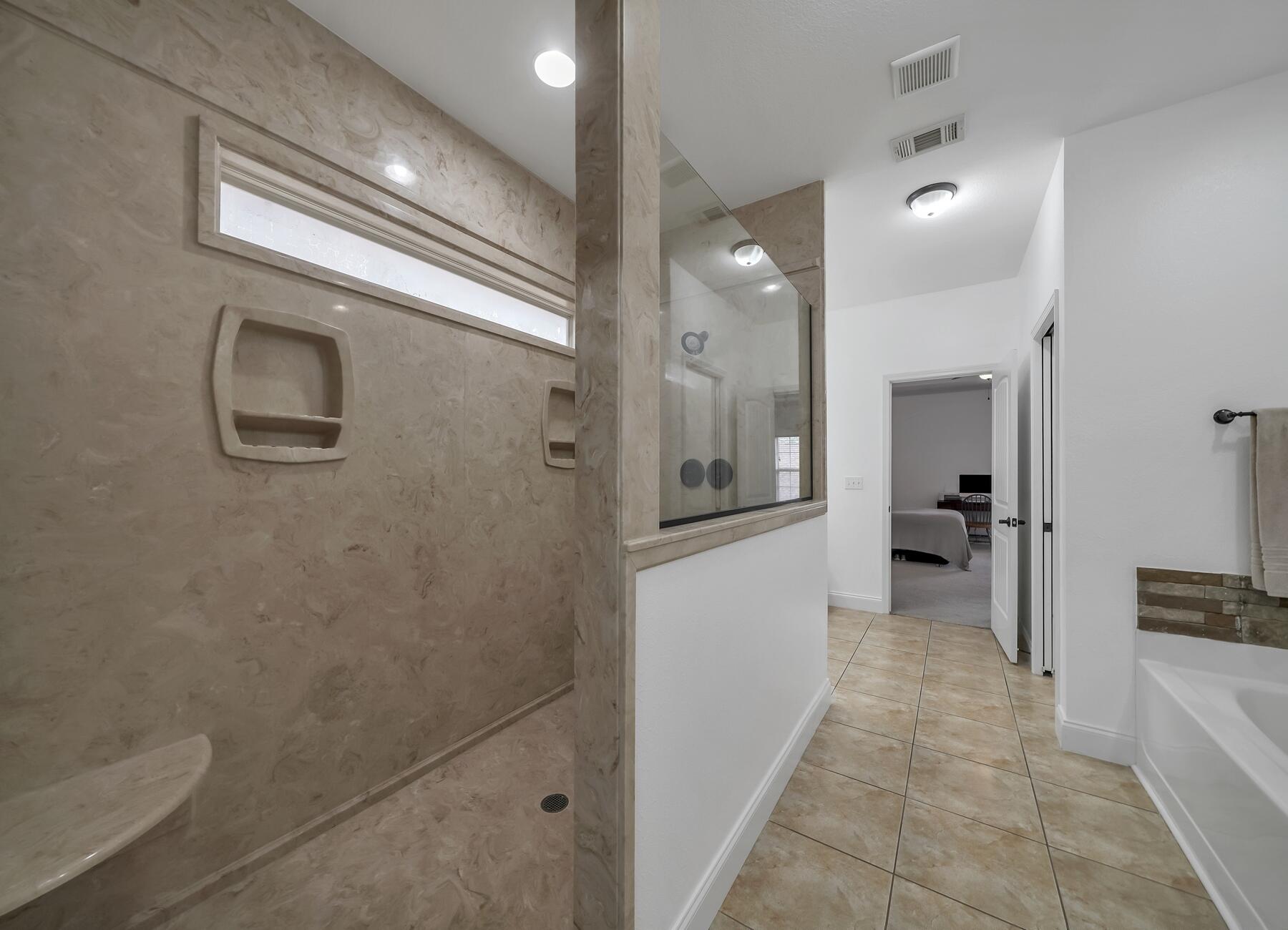 4413 Mirada Way Crestview, FL 32539 - Photo 17 of 30 a bathroom with a bathtub and a shower