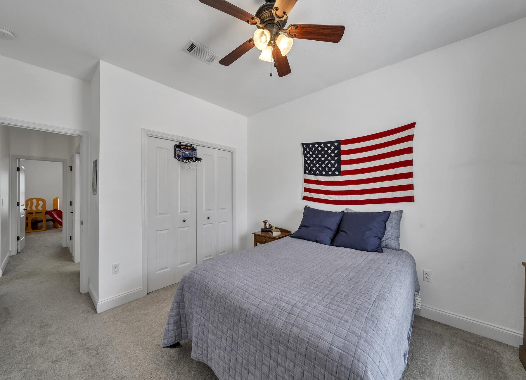 4413 Mirada Way Crestview, FL 32539 - Photo 20 of 30 a bedroom with a bed and a chandelier