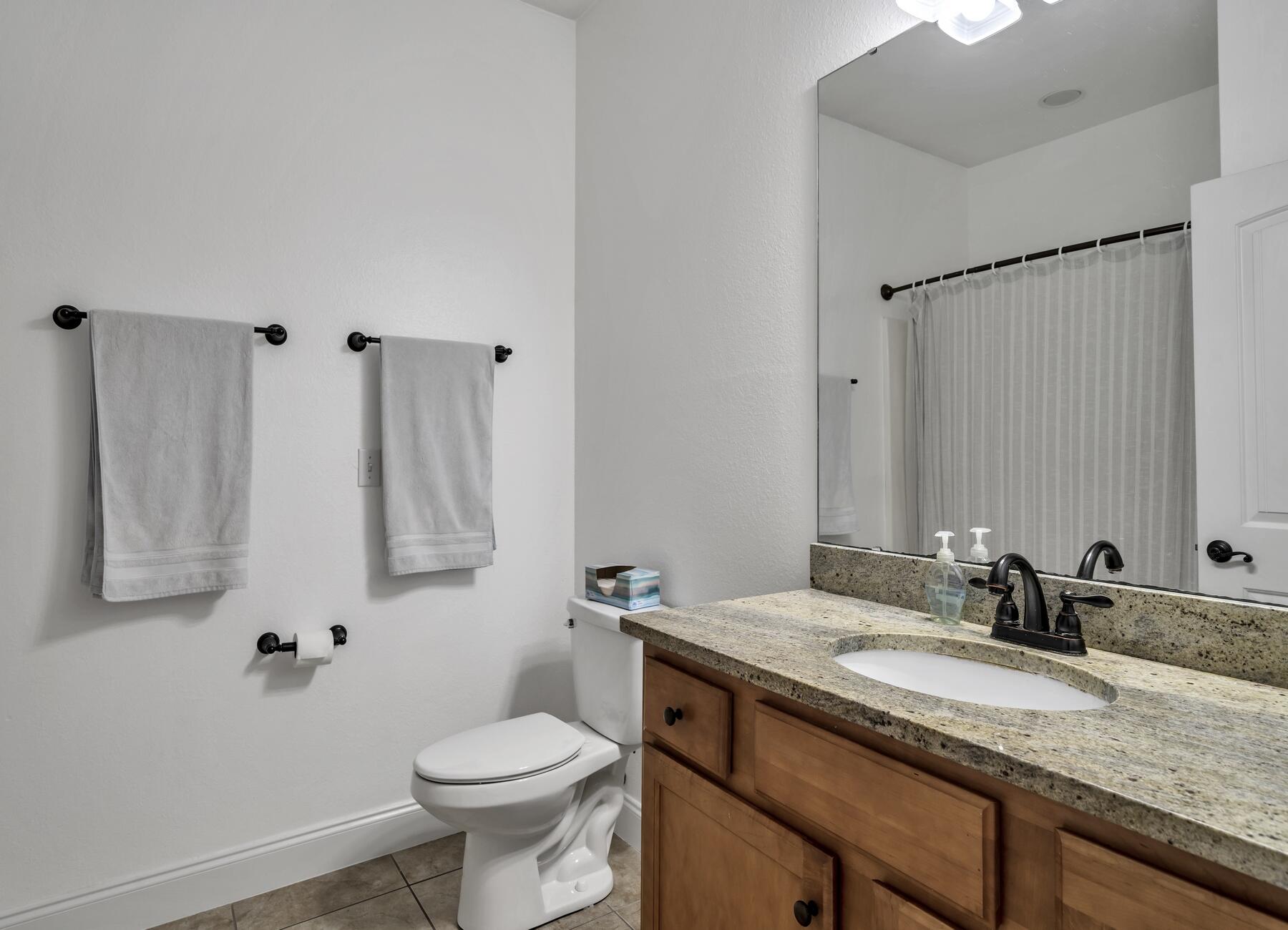 4413 Mirada Way Crestview, FL 32539 - Photo 21 of 30 a bathroom with a granite countertop sink toilet and a mirror