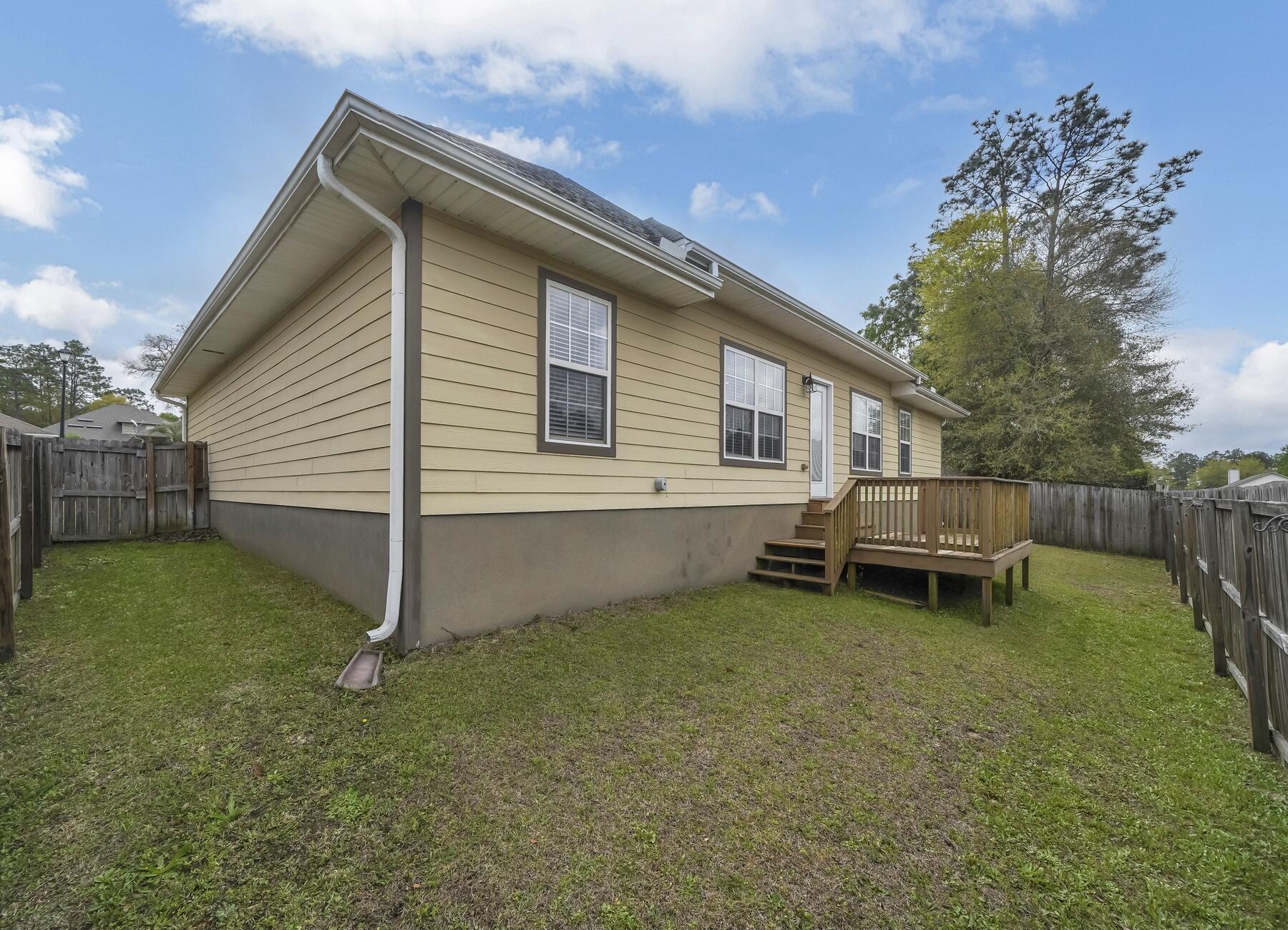 4413 Mirada Way Crestview, FL 32539 - Photo 29 of 30 a backyard of a house with table and chairs