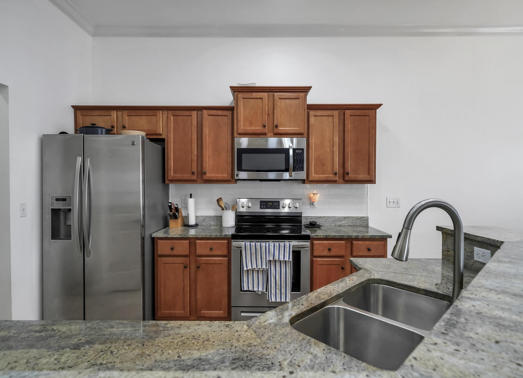 4413 Mirada Way Crestview, FL 32539 - Photo 8 of 30 a kitchen with granite countertop a refrigerator and a sink