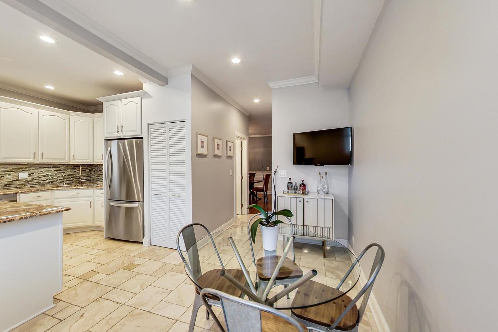 4342 North Sheridan Road, Unit 1N Chicago, IL 60613 - Photo 16 of 29 a view of a kitchen with a table and chairs