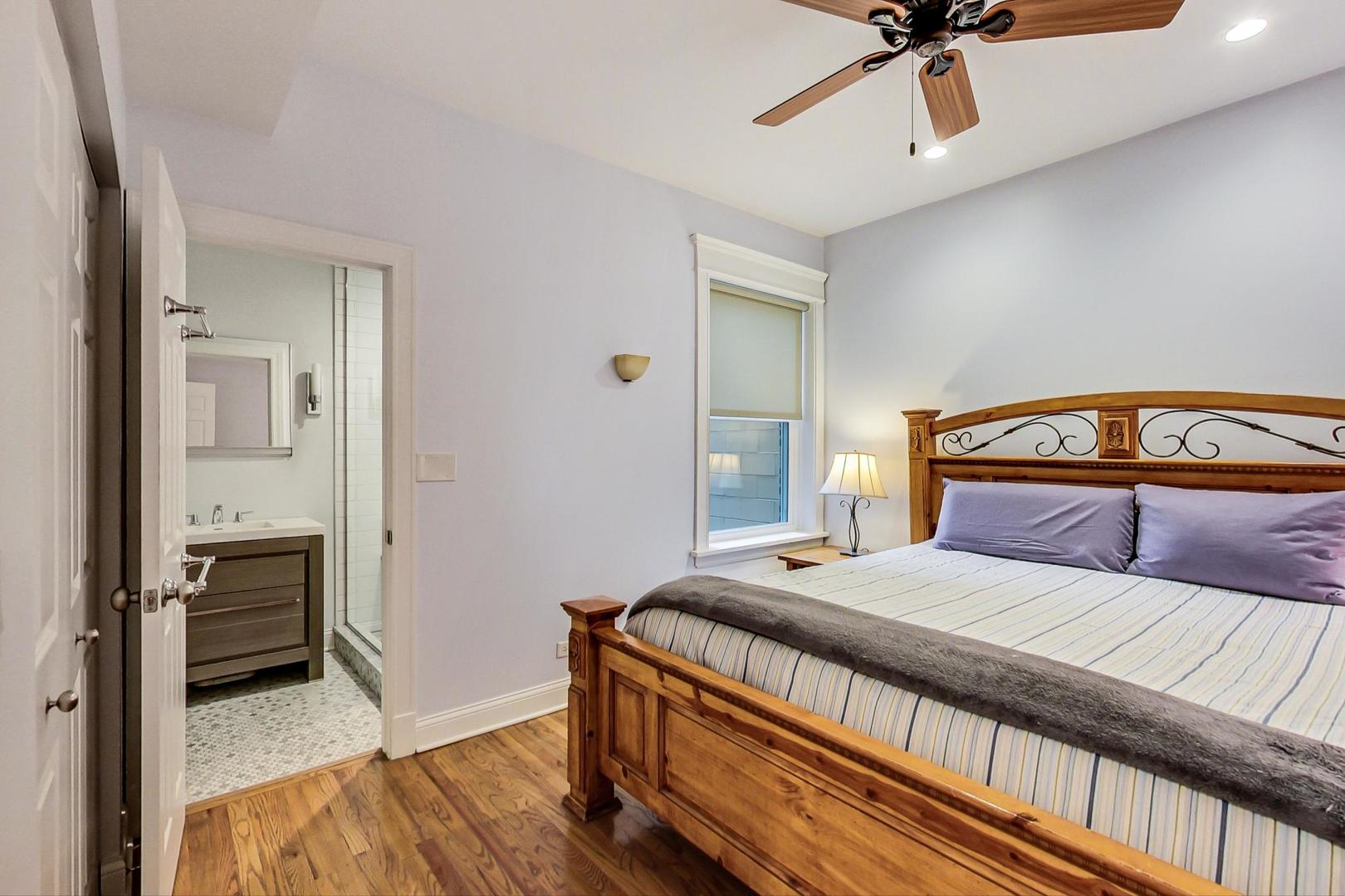 4342 North Sheridan Road, Unit 1N Chicago, IL 60613 - Photo 18 of 29 a bedroom with a bed and a chandelier