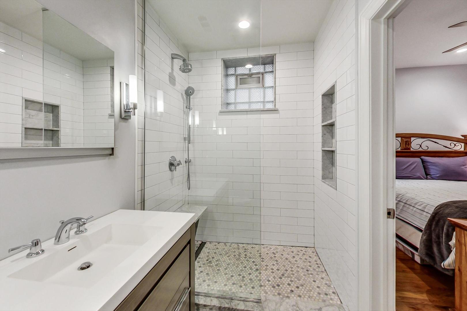 4342 North Sheridan Road, Unit 1N Chicago, IL 60613 - Photo 19 of 29 a bathroom with a sink a shower and a mirror