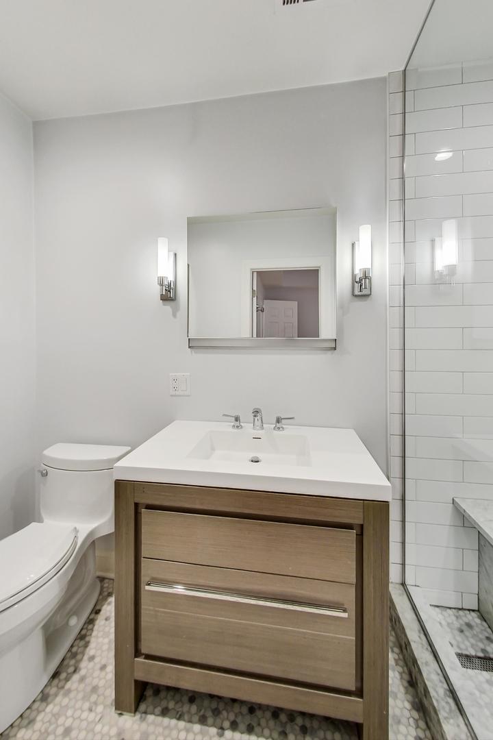 4342 North Sheridan Road, Unit 1N Chicago, IL 60613 - Photo 20 of 29 a bathroom with a sink toilet and mirror