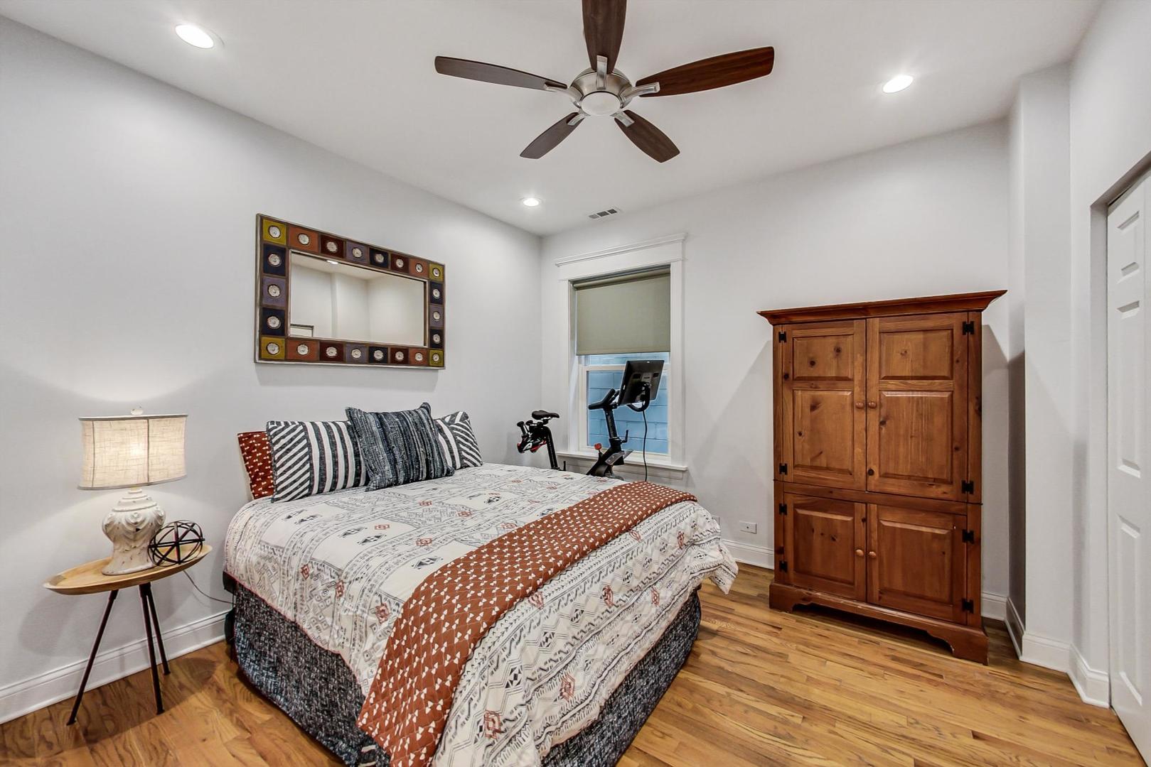 4342 North Sheridan Road, Unit 1N Chicago, IL 60613 - Photo 21 of 29 a bedroom with a bed and a chandelier