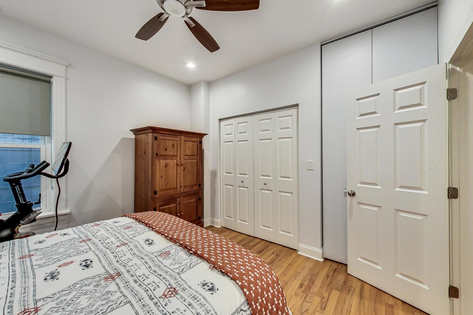 4342 North Sheridan Road, Unit 1N Chicago, IL 60613 - Photo 23 of 29 a bedroom with a bed and a chandelier