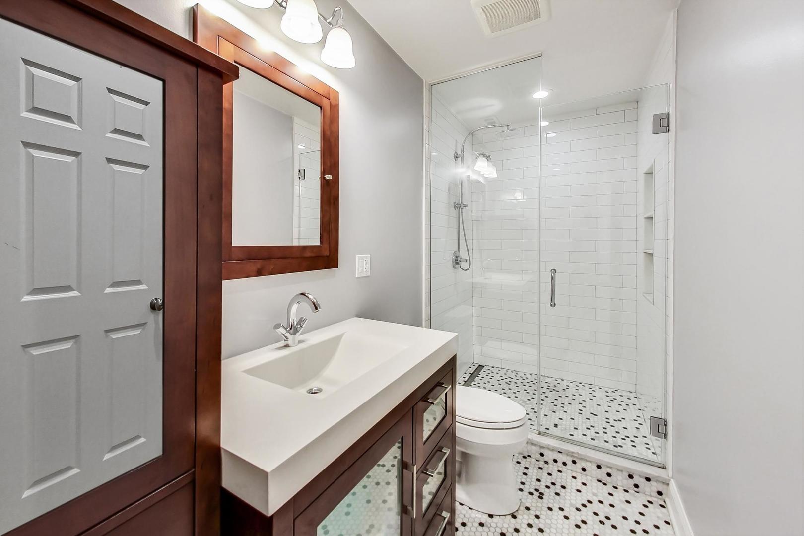 4342 North Sheridan Road, Unit 1N Chicago, IL 60613 - Photo 24 of 29 a bathroom with a sink a toilet and shower
