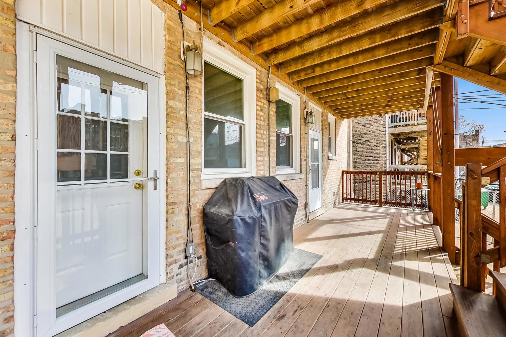 4342 North Sheridan Road, Unit 1N Chicago, IL 60613 - Photo 27 of 29 a view of a porch with wooden floor and iron stairs