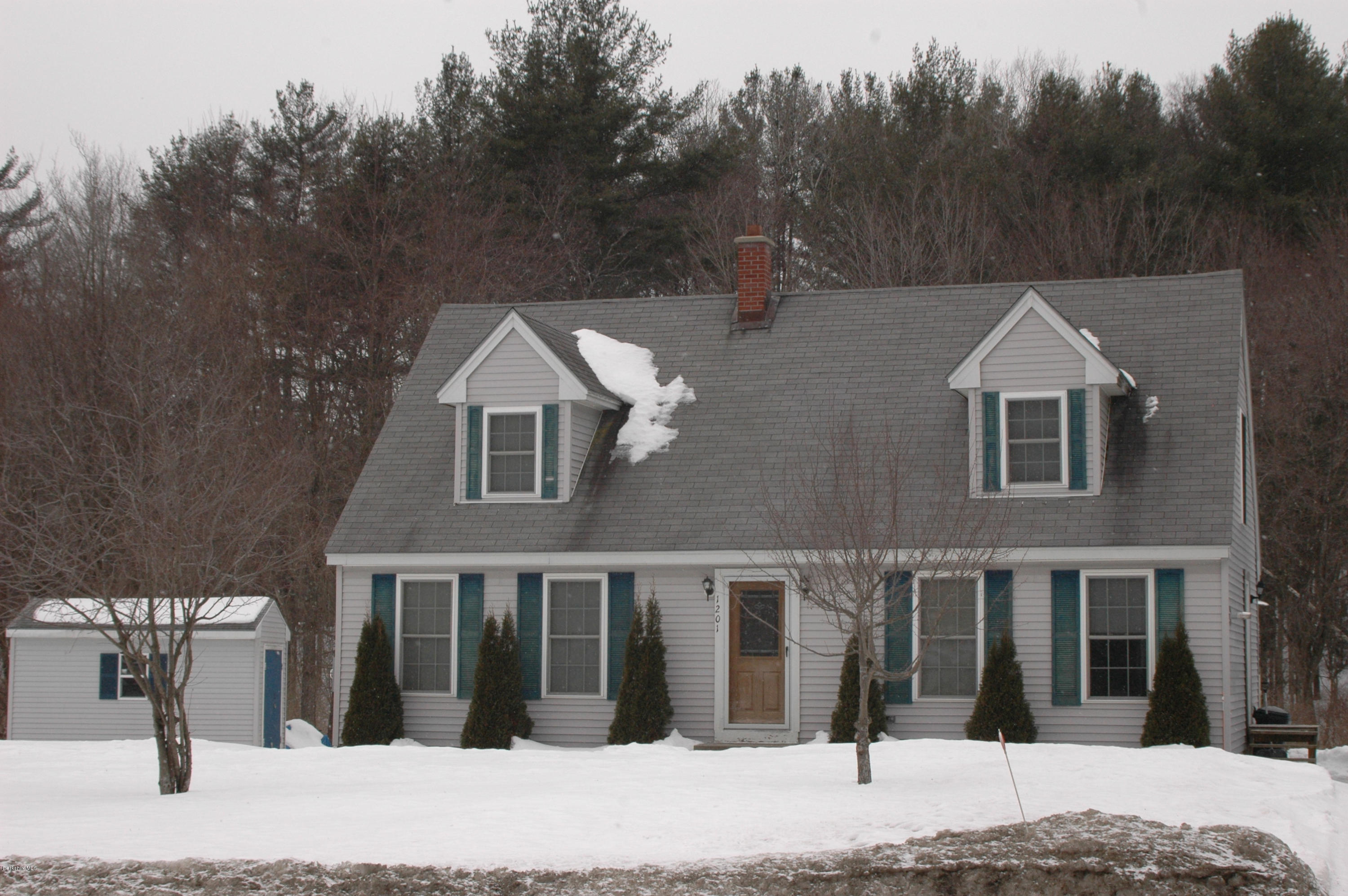 1201 River Road Clarksburg, MA 01247 - Photo 1 of 42 a view of a brick house with large windows and large trees