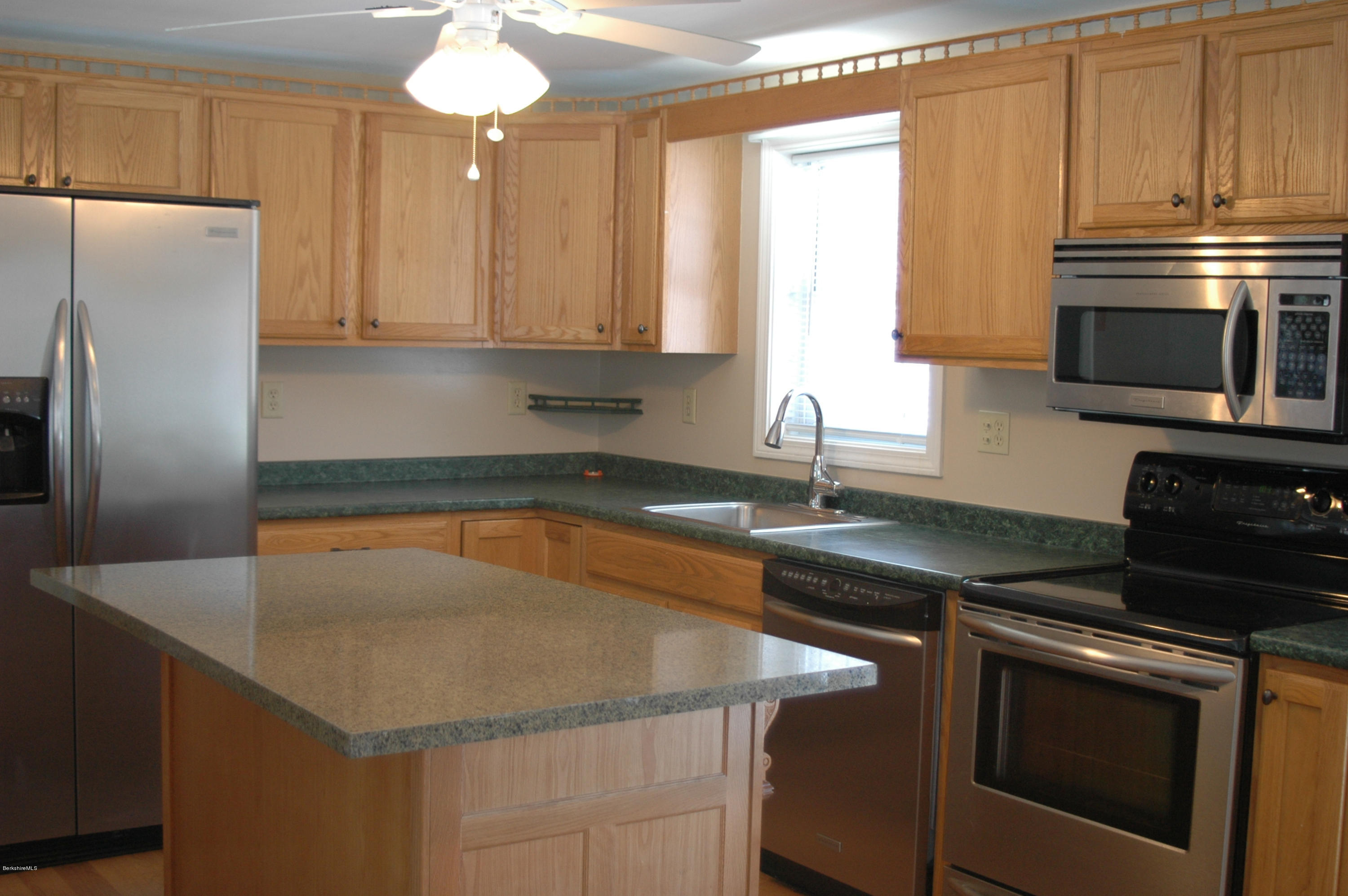 1201 River Road Clarksburg, MA 01247 - Photo 14 of 42 a kitchen with stainless steel appliances granite countertop a sink stove and refrigerator