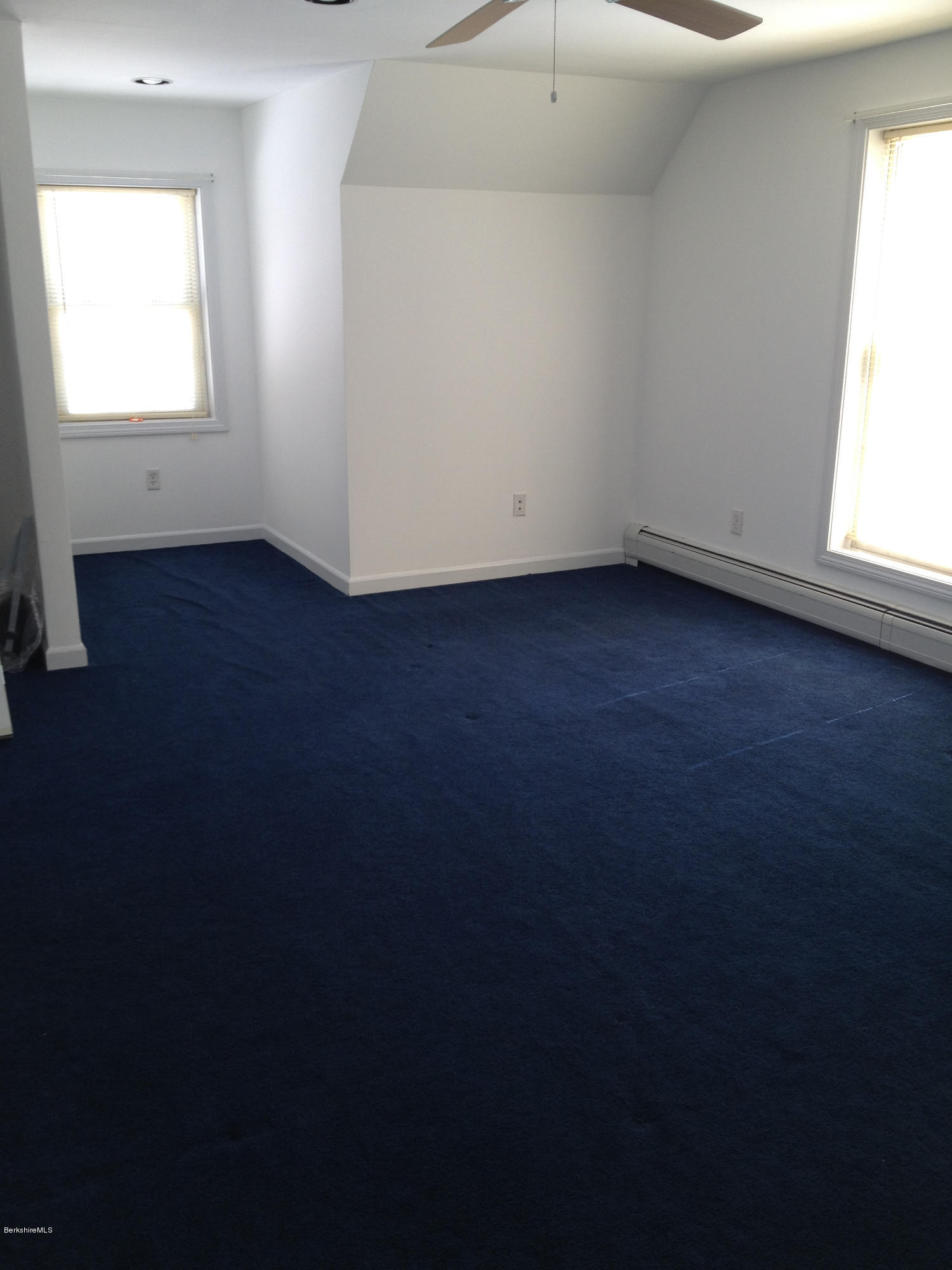 1201 River Road Clarksburg, MA 01247 - Photo 23 of 42 an empty room with wooden floor and windows