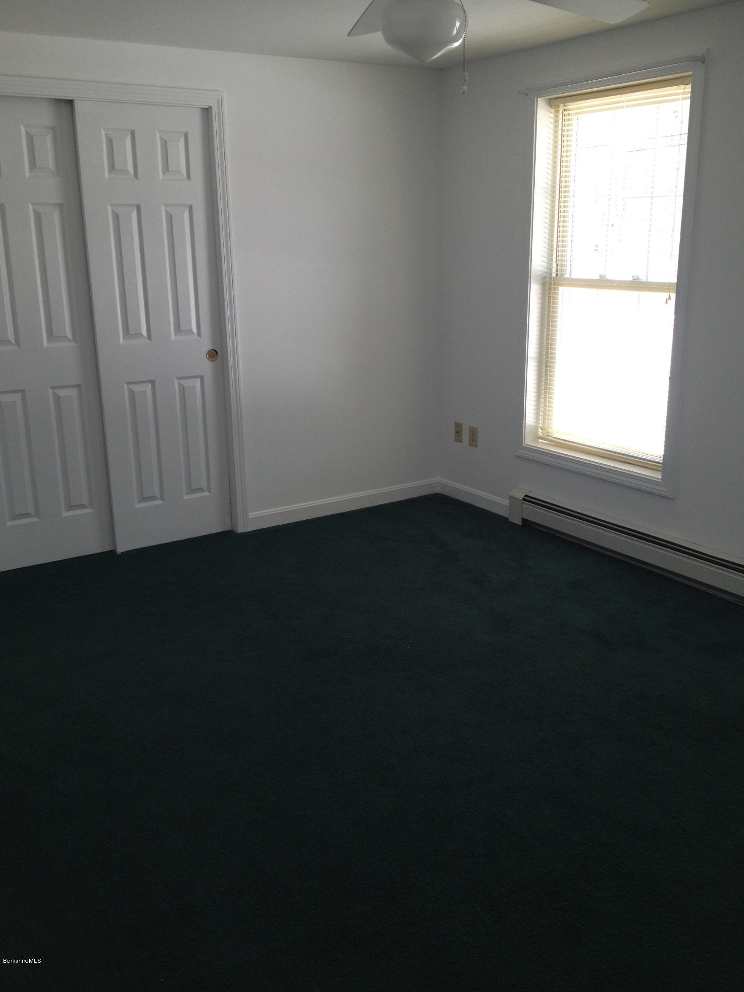 1201 River Road Clarksburg, MA 01247 - Photo 25 of 42 a view of an empty room with wooden floor and a window