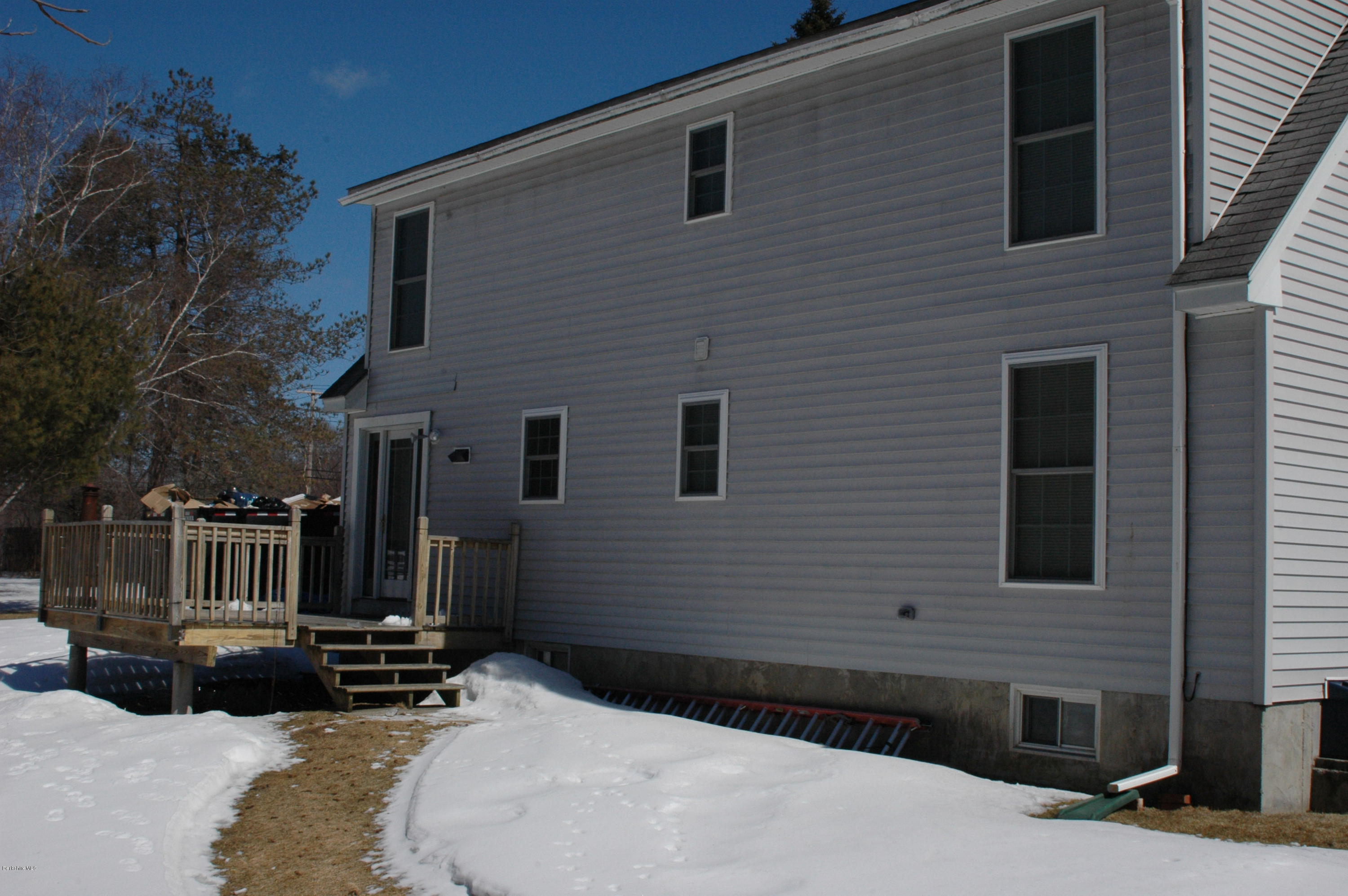 1201 River Road Clarksburg, MA 01247 - Photo 8 of 42 a side view of a house with wooden fence