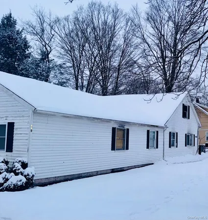 a house that has a tree in front of the house