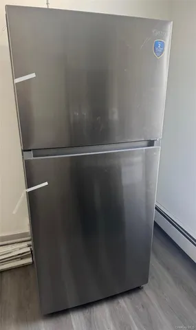 a view of a refrigerator and wooden floor