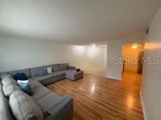 a view of empty room with wooden floor