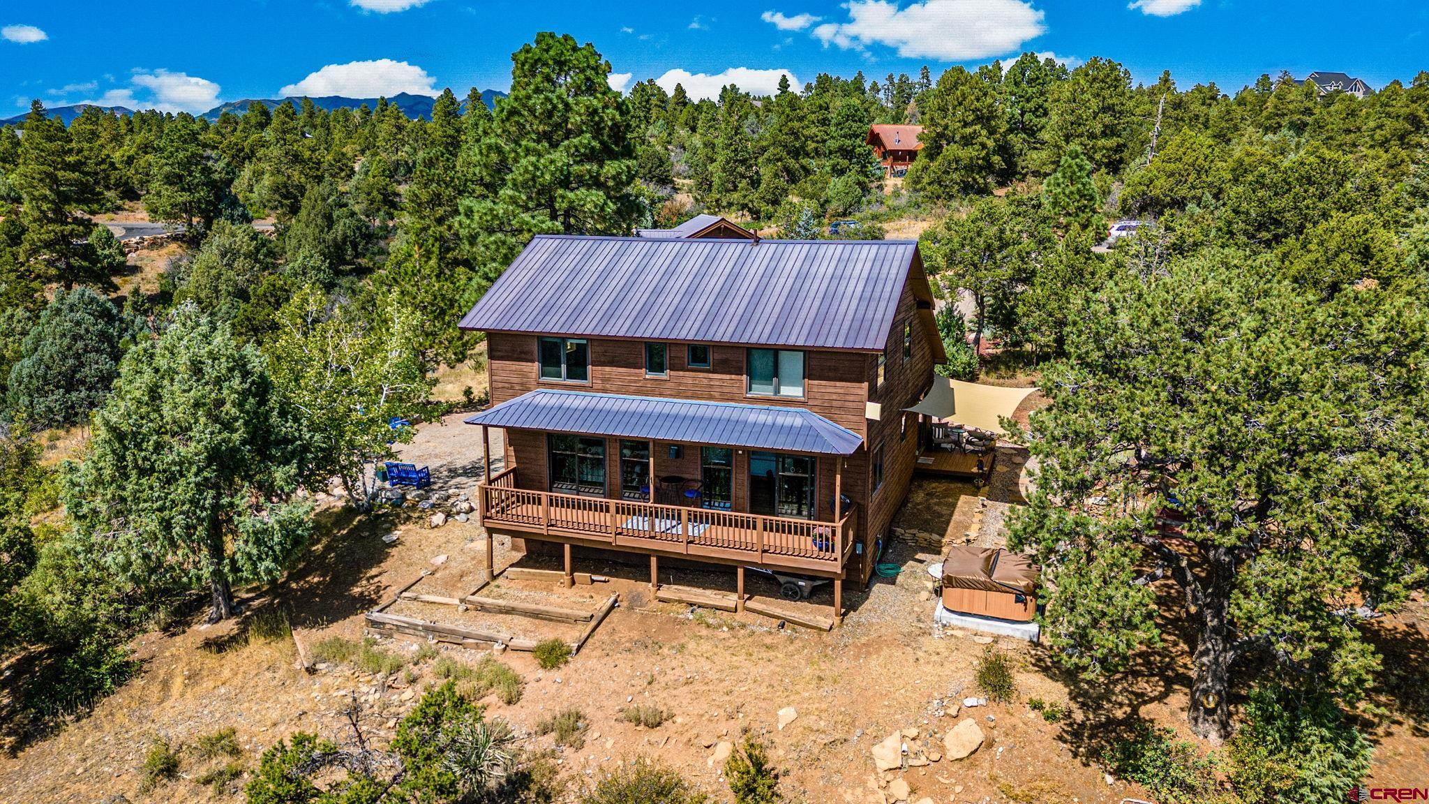 310 Far View Road Durango, CO 81303 - Photo 2 of 35 a view of a small yard with wooden fence