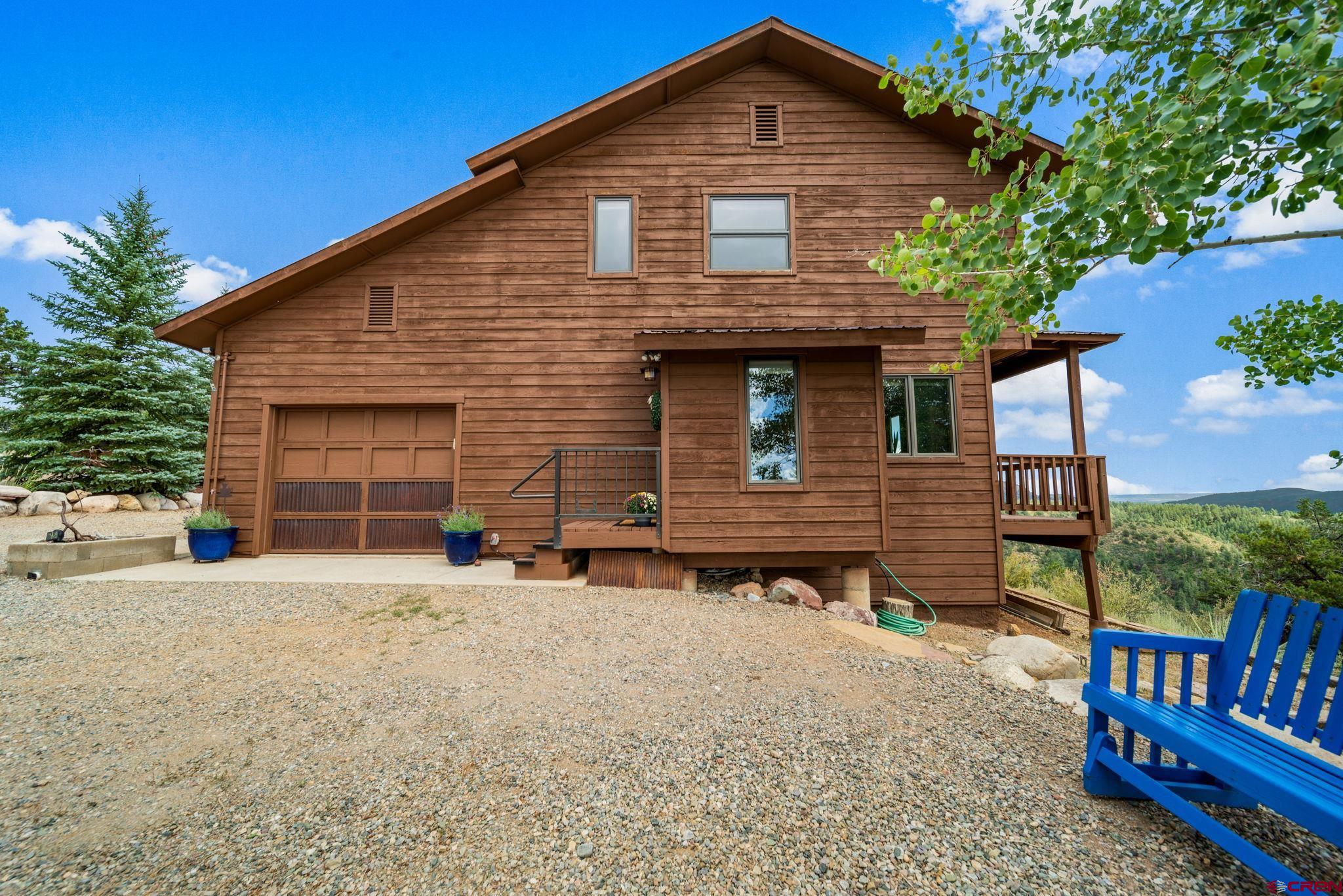 310 Far View Road Durango, CO 81303 - Photo 3 of 35 a front view of a house with garden