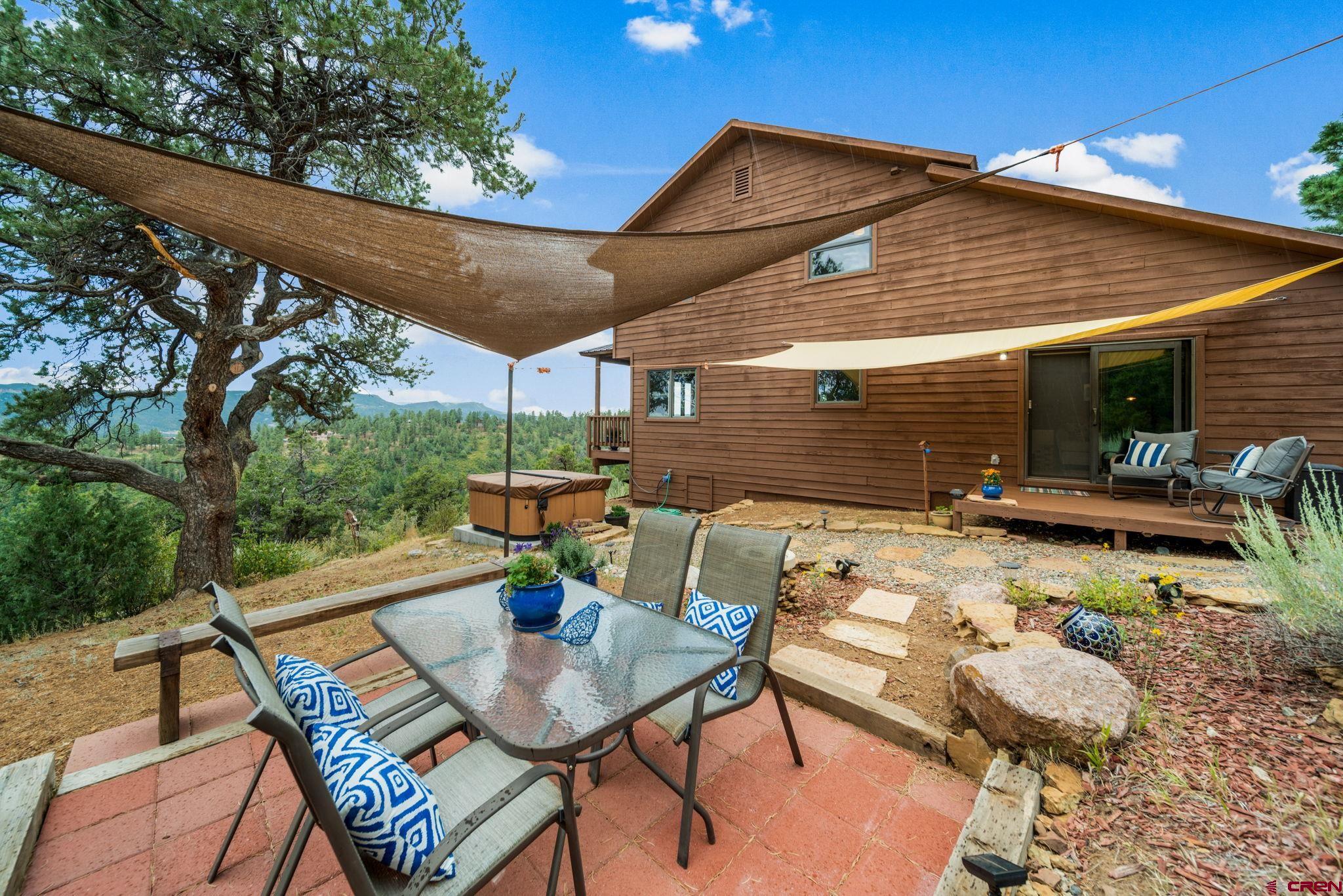 310 Far View Road Durango, CO 81303 - Photo 31 of 35 a view of a patio with a table and chairs under an umbrella