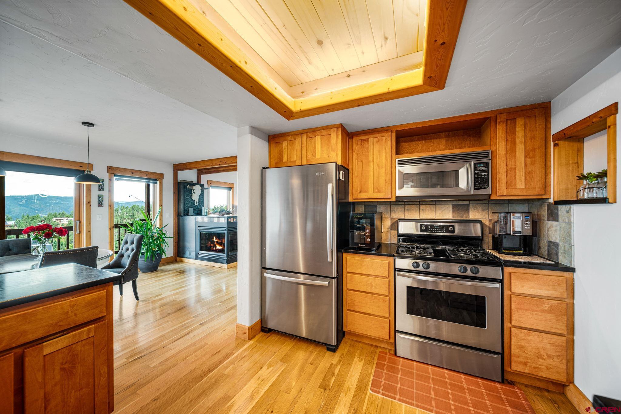 310 Far View Road Durango, CO 81303 - Photo 9 of 35 a kitchen with stainless steel appliances a stove top oven a sink and a refrigerator