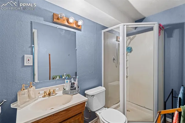 a white toilet sitting next to a bathroom sink