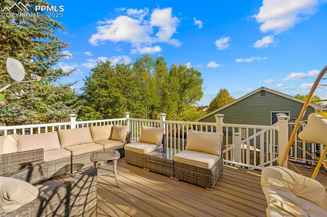 a roof deck with couches and wooden floor