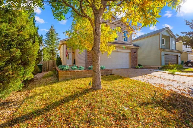 a view of backyard of house with green space