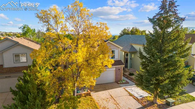 an aerial view of a house with a yard