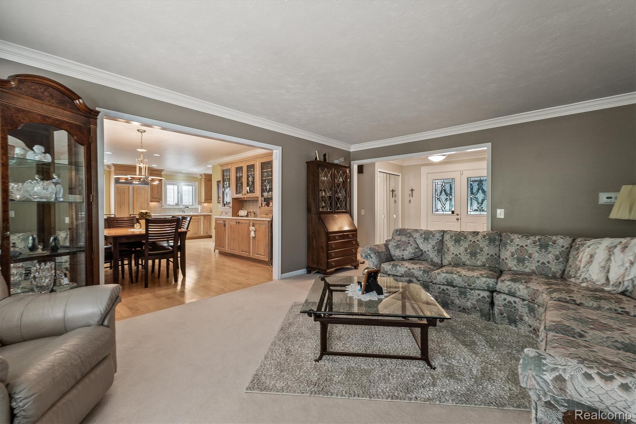 1662 Sumac Drive Rochester, MI 48309 - Photo 8 of 38 Open concept main living space featuring crown molding and neutral wall tones