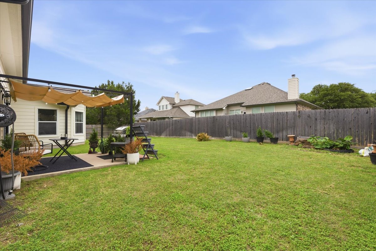 2501 Aspen Meadow Road Leander, TX 78641 - Photo 22 of 30 Expansive green lawn with a privacy fence