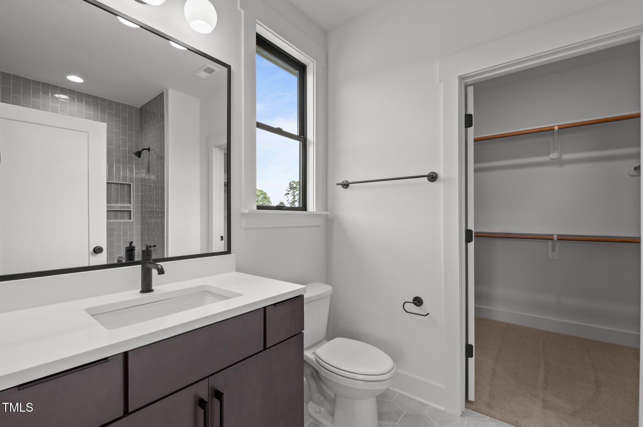 200 Broadleaf Lane Louisburg, NC 27549 - Photo 34 of 57 a bathroom with a sink toilet and shower