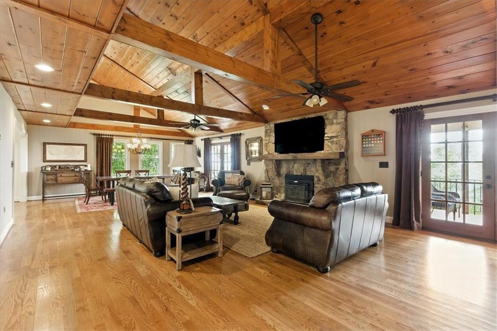 11 Brow Road Rome, GA 30165 - Photo 11 of 58 a living room with furniture a flat screen tv and a floor to ceiling window