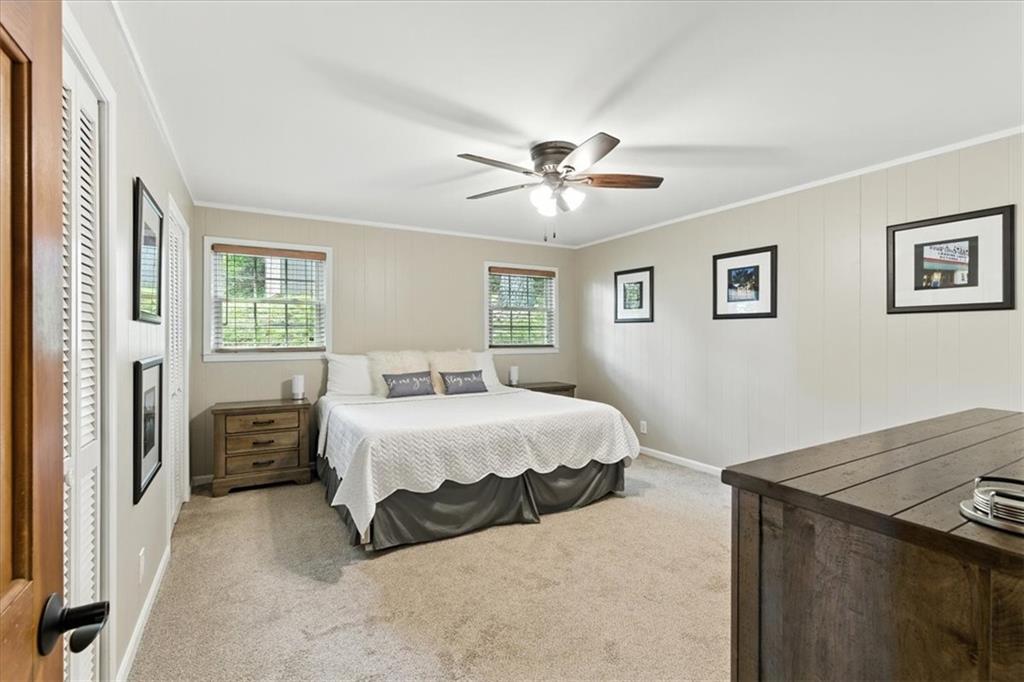 11 Brow Road Rome, GA 30165 - Photo 15 of 58 a spacious bedroom with a bed and a chandelier