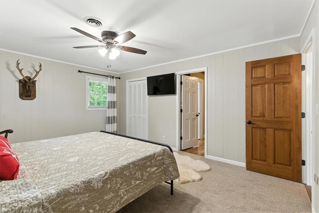 11 Brow Road Rome, GA 30165 - Photo 21 of 58 a bedroom with a large bed and a chandelier