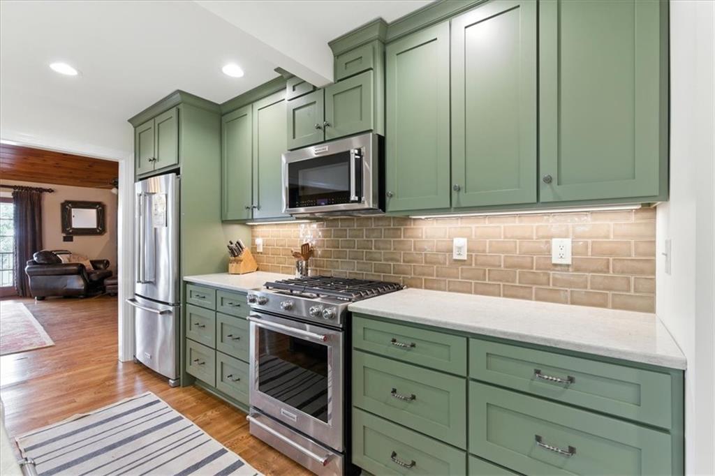 11 Brow Road Rome, GA 30165 - Photo 7 of 58 a kitchen with stainless steel appliances granite countertop a stove a sink and a microwave