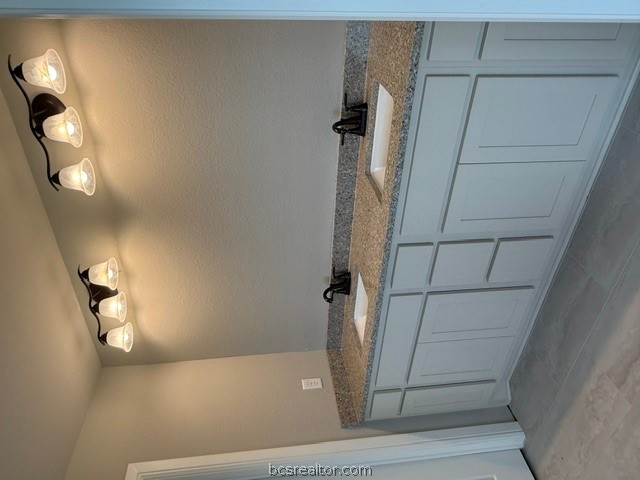 6428 Raleigh Loop College Station, TX 77845 - Photo 15 of 20 a bathroom with a granite countertop sink and a mirror