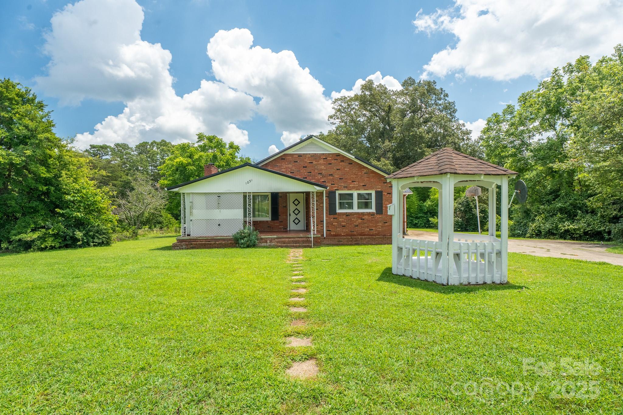 a front view of a house with a garden