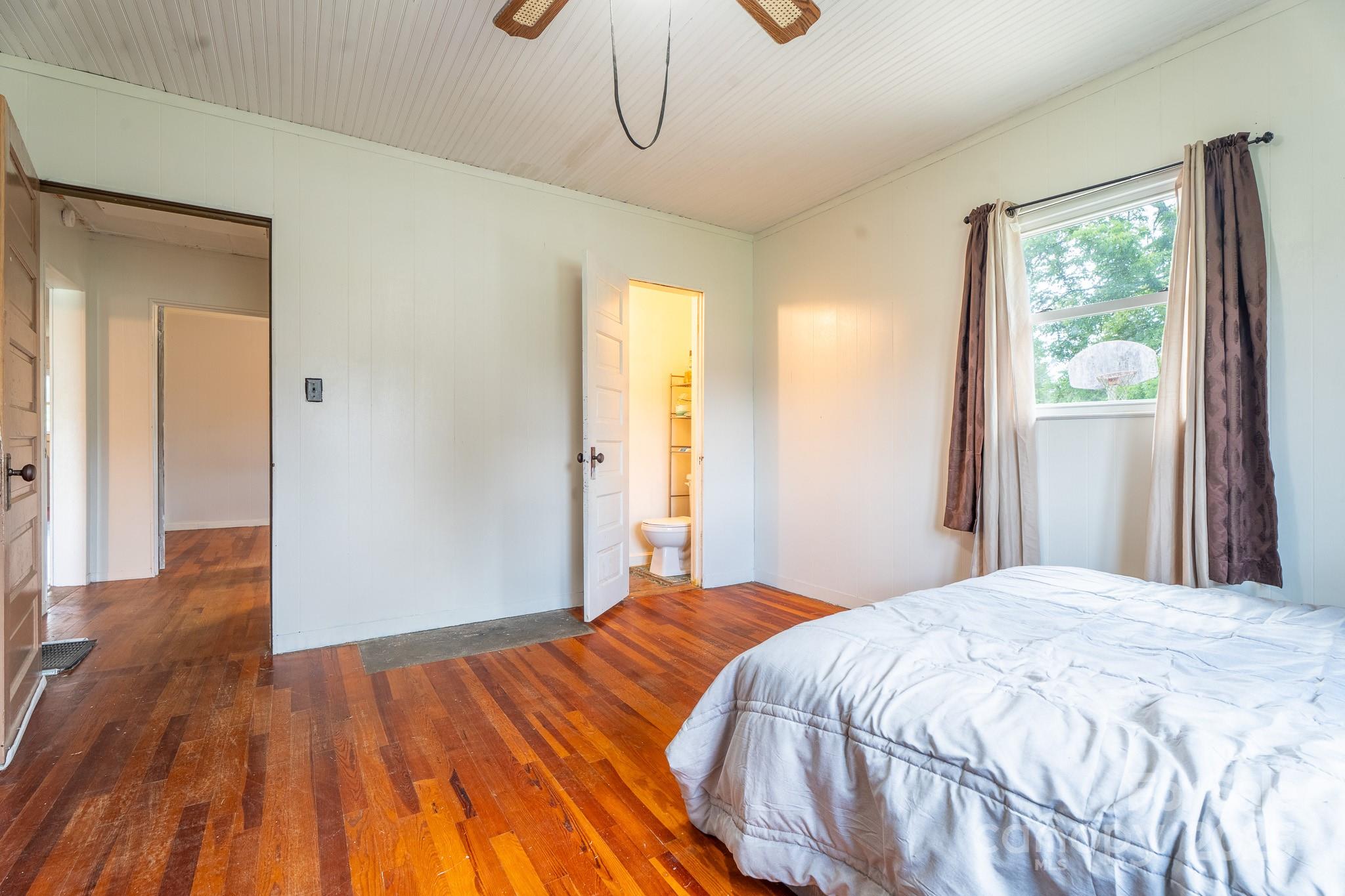 1851 Enon Road Valdese, NC 28690 - Photo 13 of 30 a bedroom with a bed and wooden floor