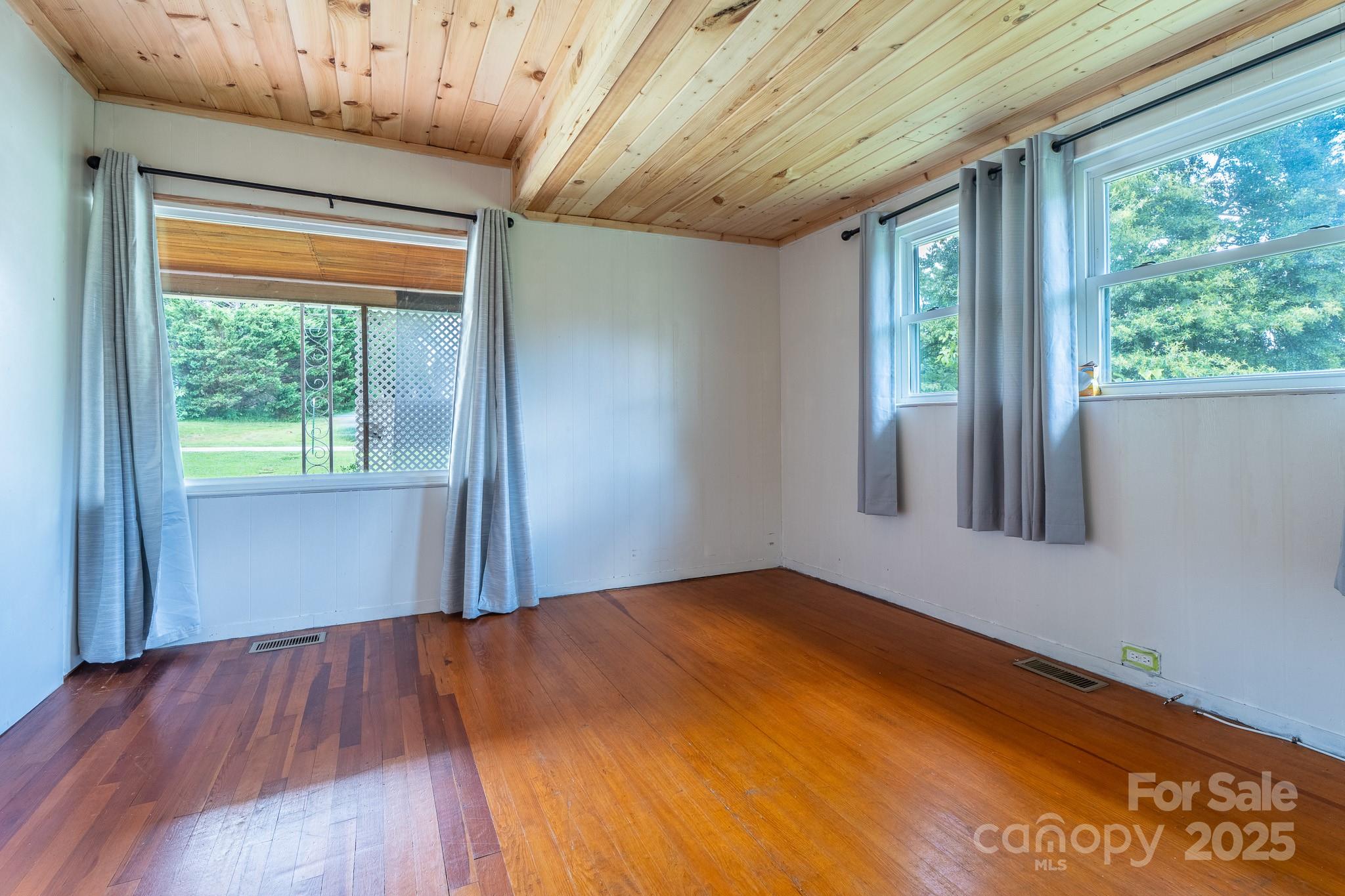 1851 Enon Road Valdese, NC 28690 - Photo 16 of 30 a view of empty room with wooden floor and fan