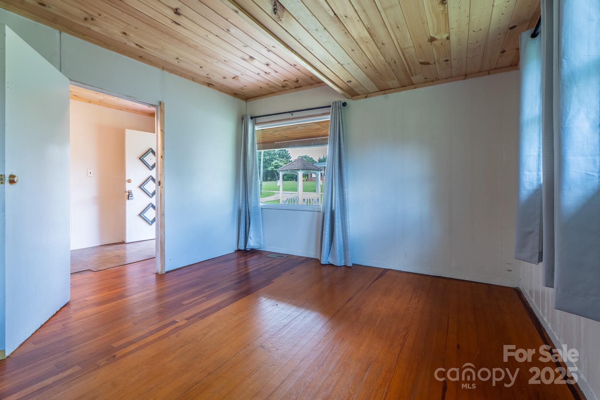 1851 Enon Road Valdese, NC 28690 - Photo 17 of 30 a view of an empty room with wooden floor and a window