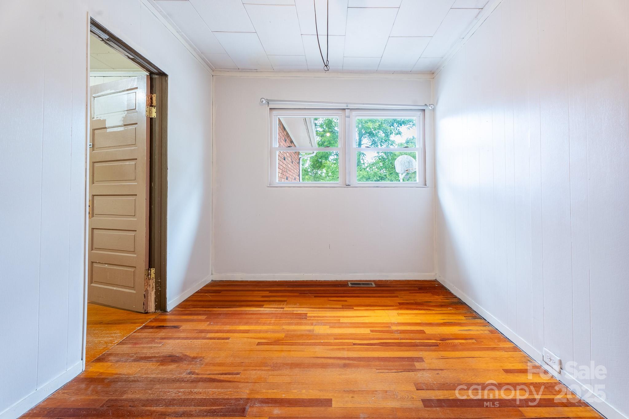 1851 Enon Road Valdese, NC 28690 - Photo 19 of 30 an empty room with wooden floor and windows
