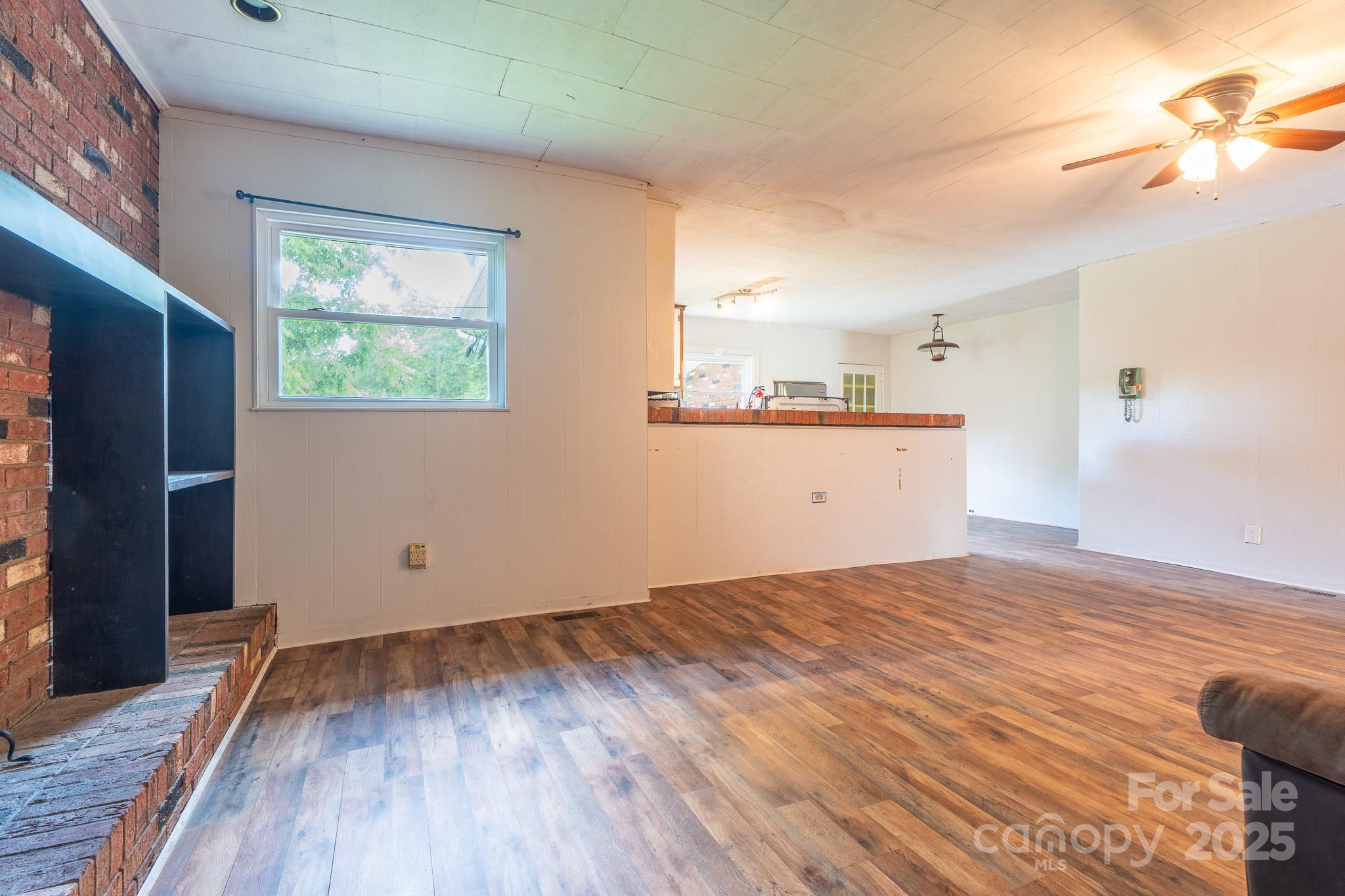 1851 Enon Road Valdese, NC 28690 - Photo 8 of 30 a view of empty room with wooden floor and fan