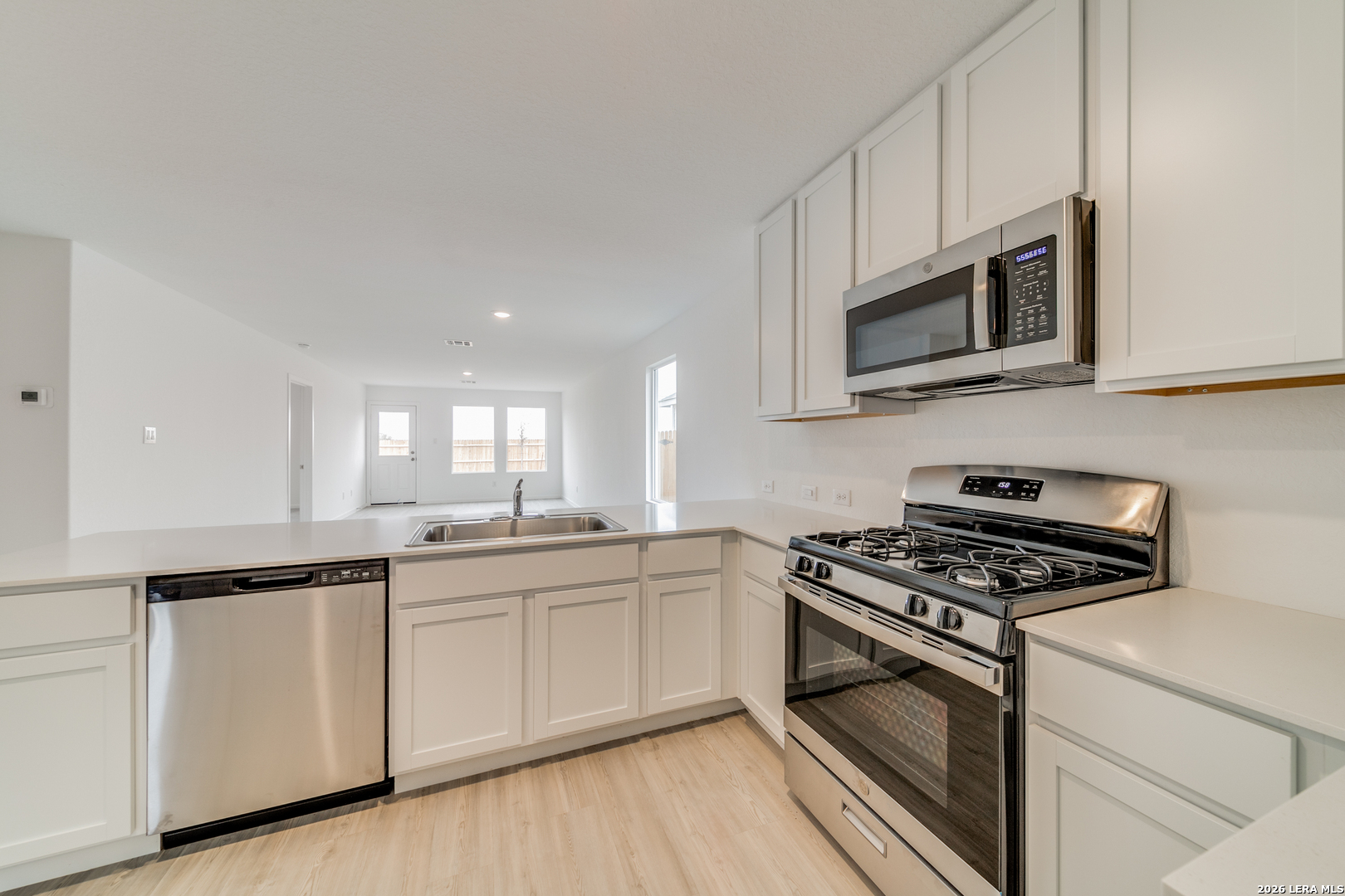 11621 Dog Rose Converse, TX 78109 - Photo 20 of 25 a kitchen with stainless steel appliances granite countertop white cabinets a sink and dishwasher